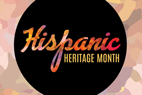 Hispanic Heritage Month written in rainbow colored cursive on a black circle background