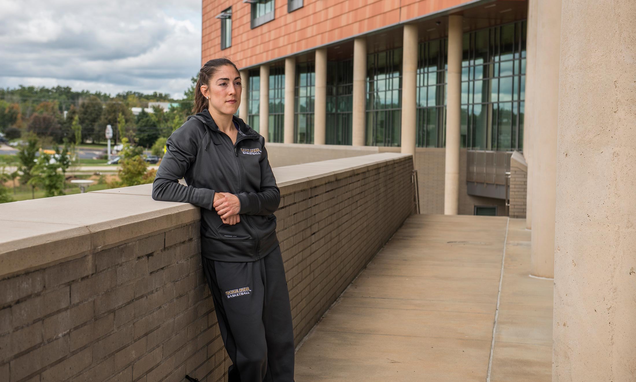 Oakland University women's basketball player Taylor Gleason stands in front of the Human Health building