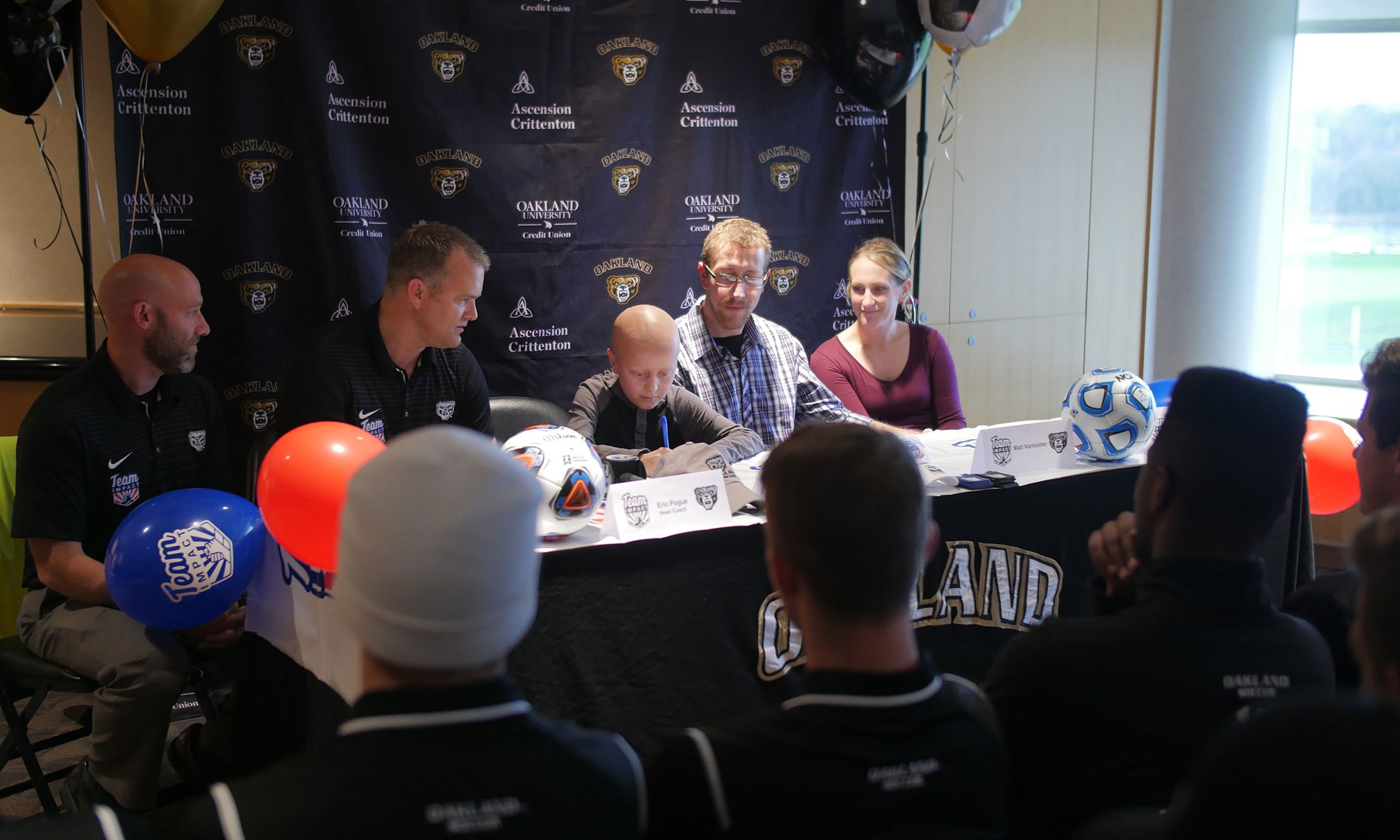 Alex VanHolder in the Oakland University Athletics Department's press room signing a letter of intent with the men's soccer team