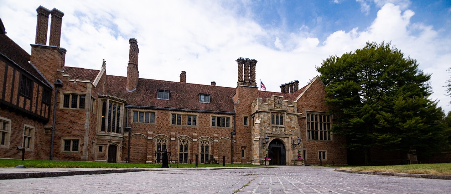 Photo of Meadow Brook Hall, a large historic brown brick building.