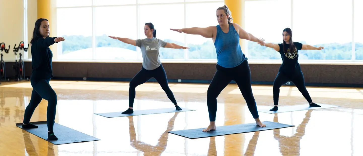 Students taking a yoga class in a studio