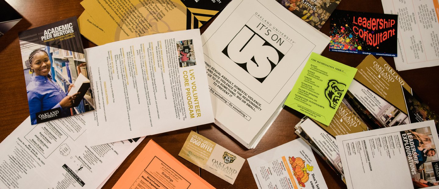 Table covered in a variety of forms and flyers