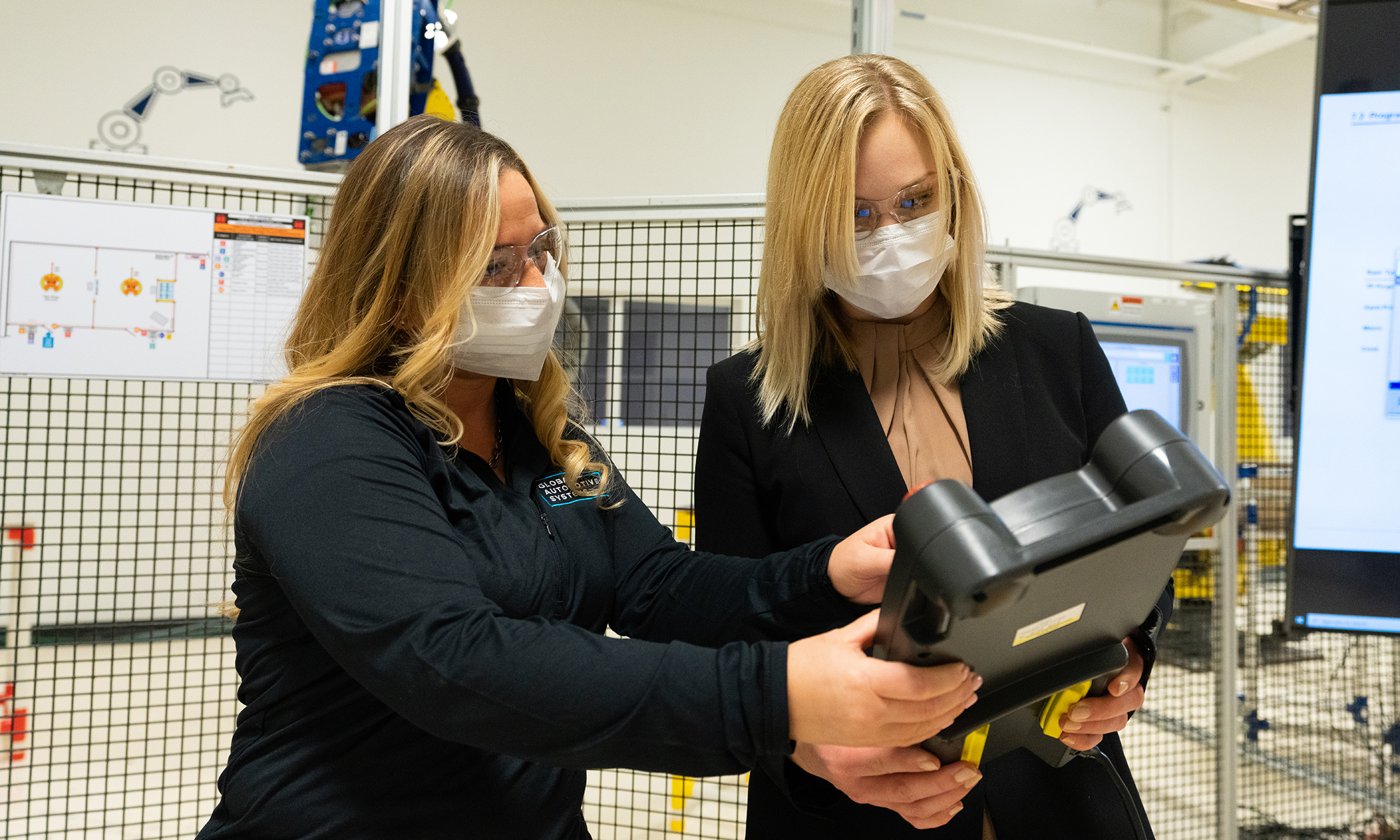 Woman showing another woman industrial hygiene equipment