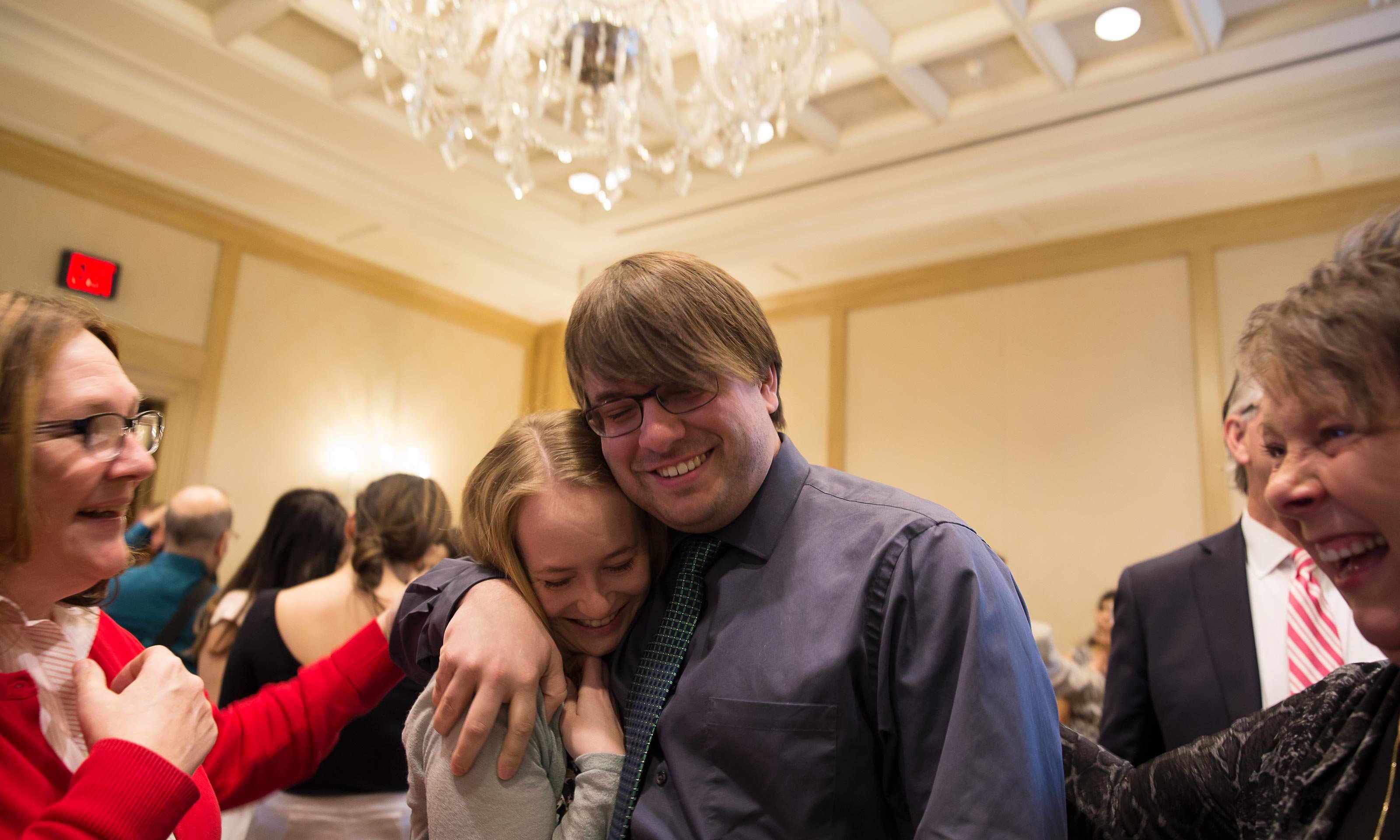 O U W B student celebrating his residency match at the Match Day 2017 ceremony, held at The Townsend Hotel in Birmingham, Michigan. Hugging a female friend in a banquet room.