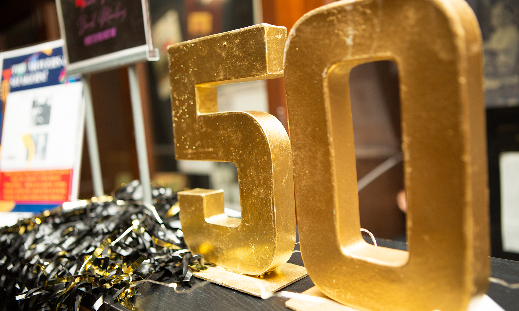 Gold "50" block letters on a table
