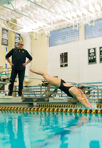Coach teaching swimmer