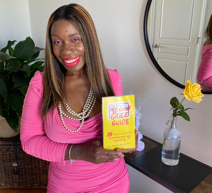 A person holding a book titled 