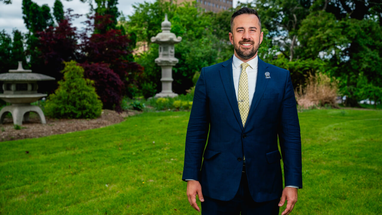 Mike McGuinness wearing suit and tie