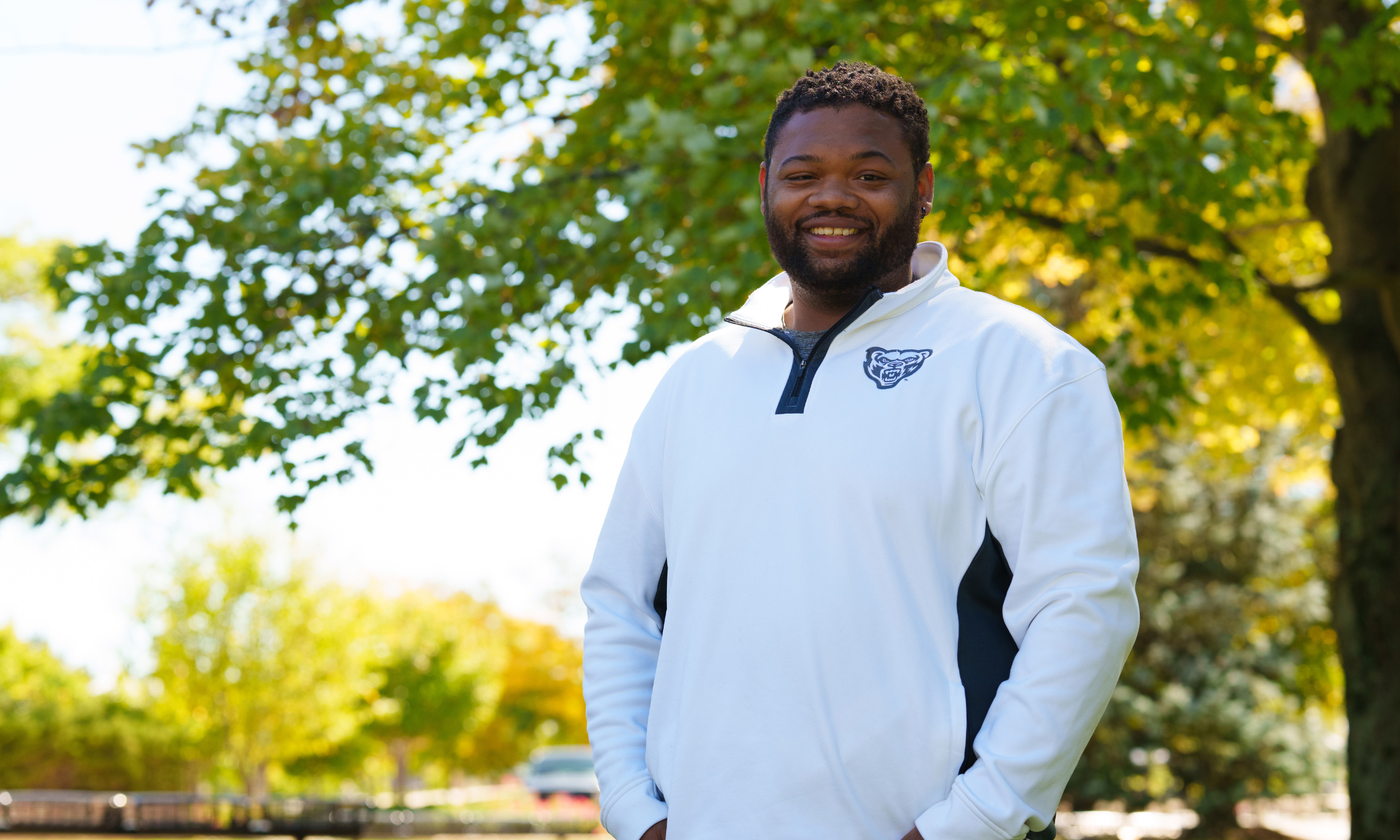 Man with OU shirt standing outside