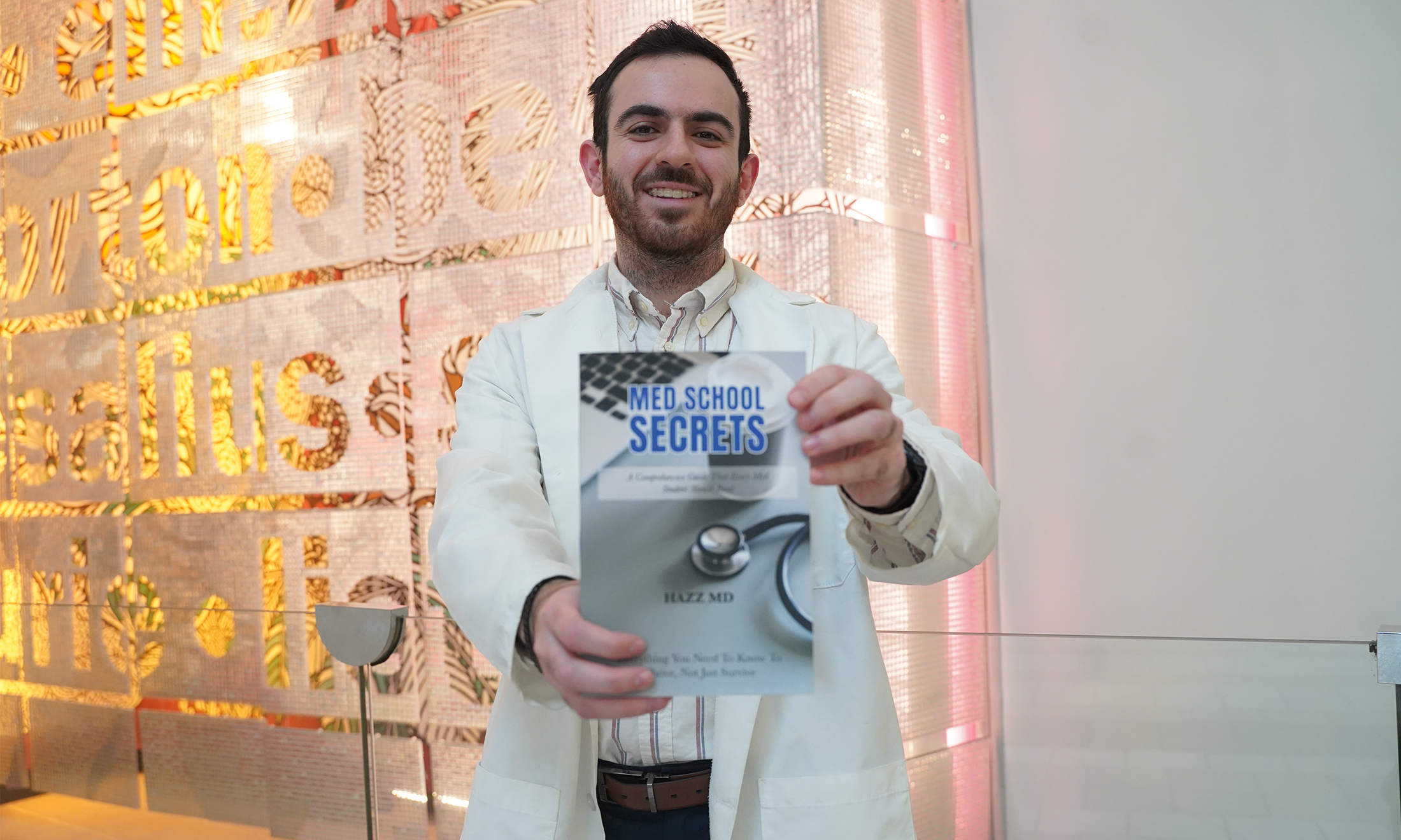 Hazem Alakhras, M.D., holds his book