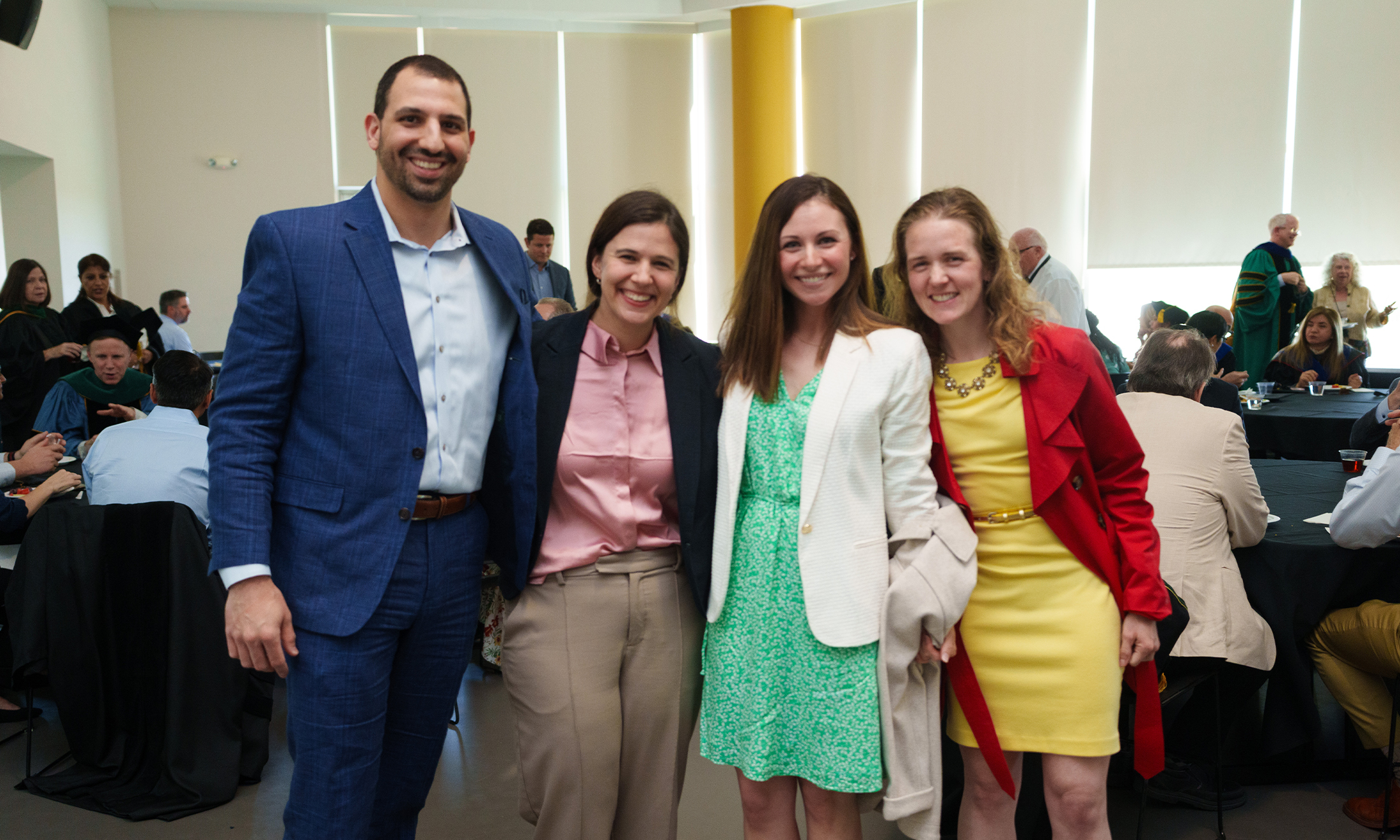 An image of four people posing for a photo