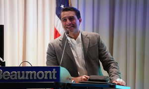 Dr. Sahi at a podium