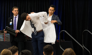 Dr. Oh assisting a student at white coat