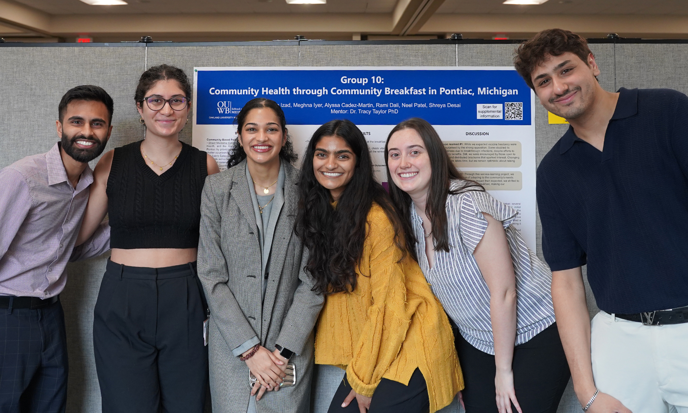 An image of students in front of their poster