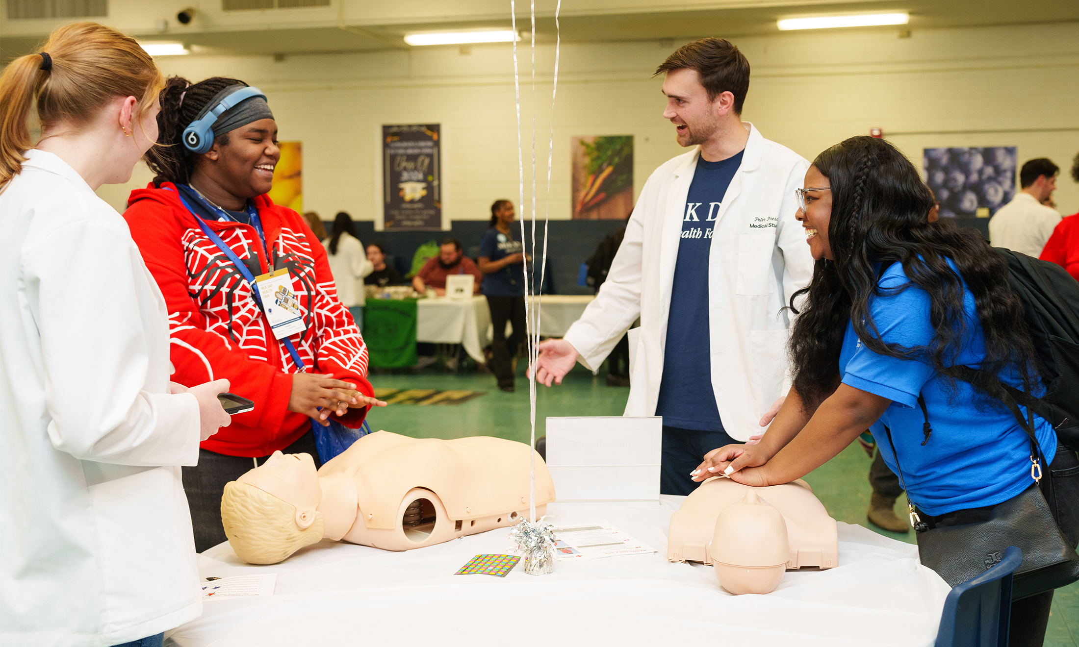 An image of students talking with each other at the health fair