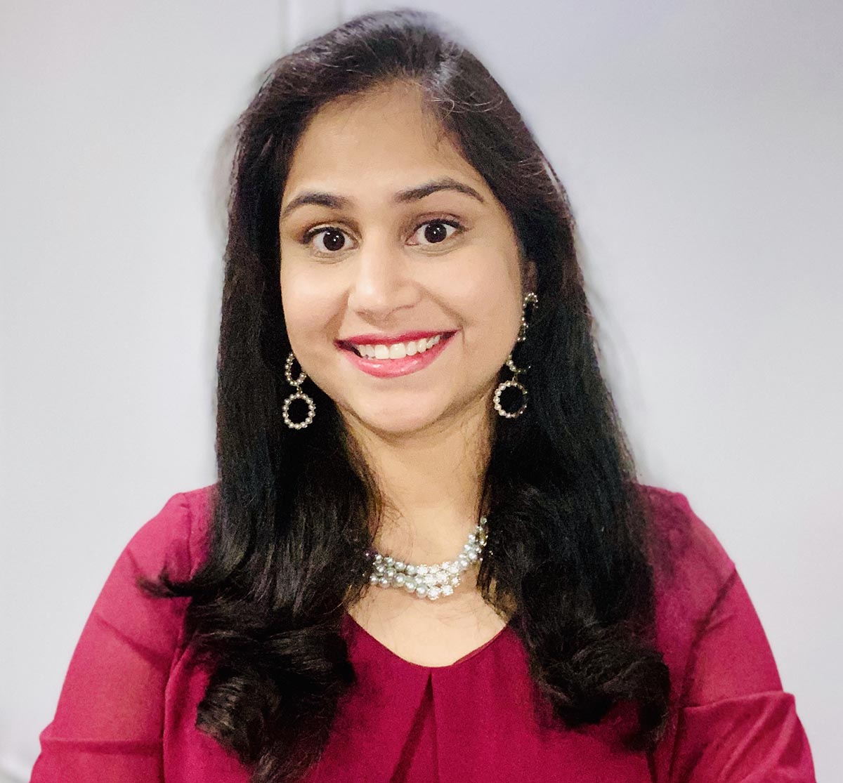 Woman in red shirt smiling at camera