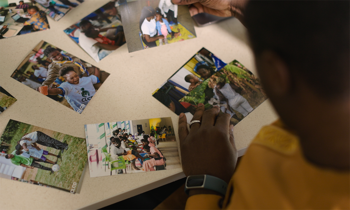 person looking at photos laid out on a table