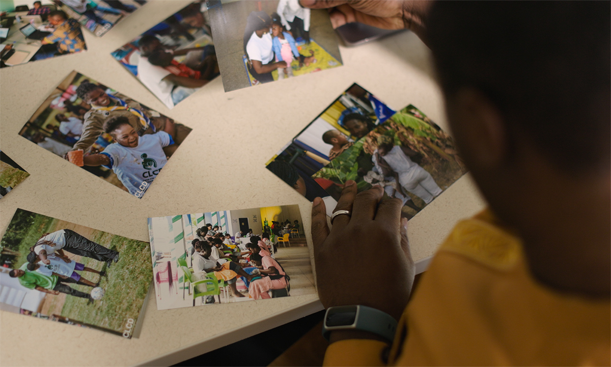 person looking at photos laid out on a table