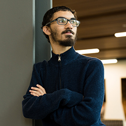 Man stands with his arms crossed.