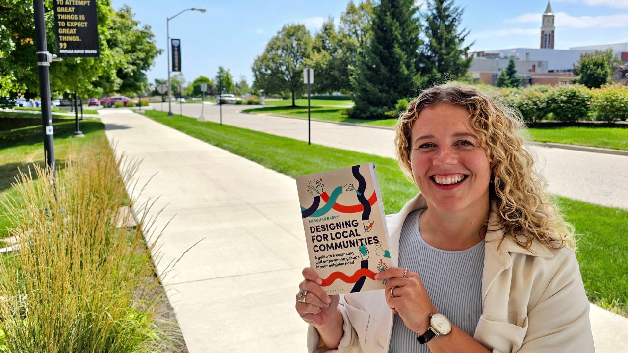 Meaghan Barry holding her new book