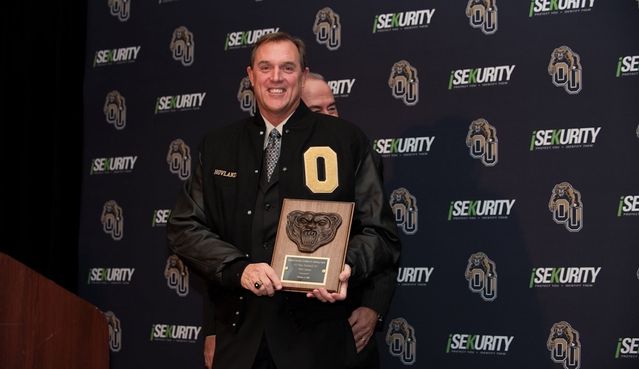 Swim and Dive Coach Pete Hovland in varsity jacket