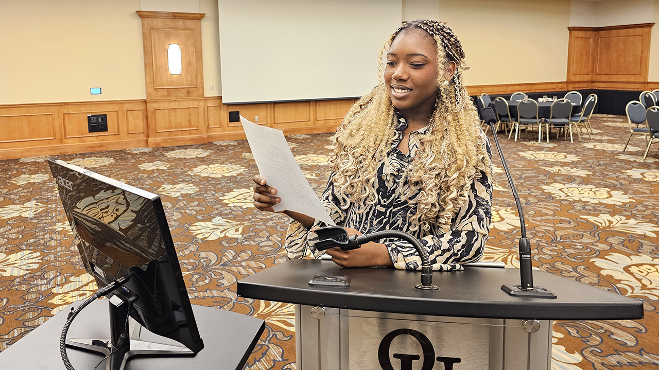 DeNetria Gibson-Phillips reads her poem at the Oakland University Board of Trustees meeting.