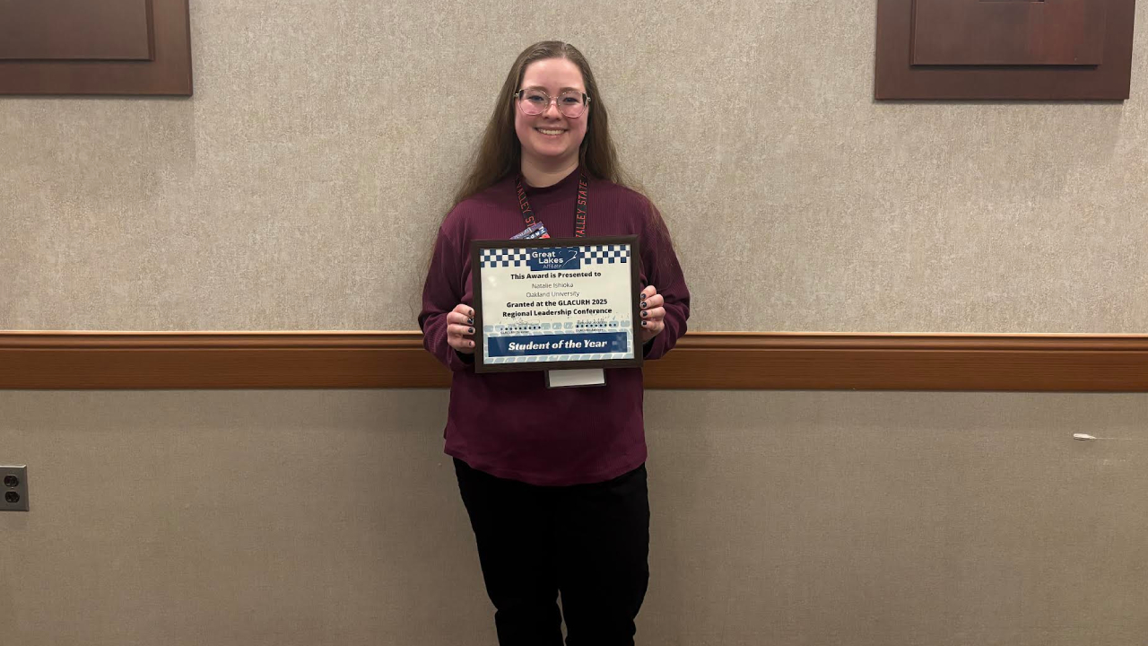 Natalie Ishioka holding award