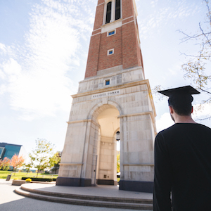 Graduated student looking up at the clock tower