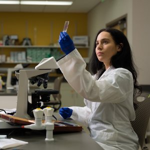 Oakland University graduate working in a lab