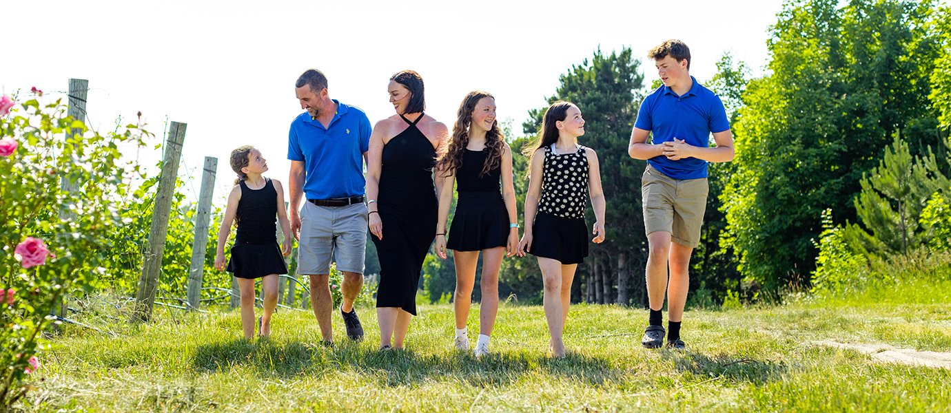 A family walking through a vineyard