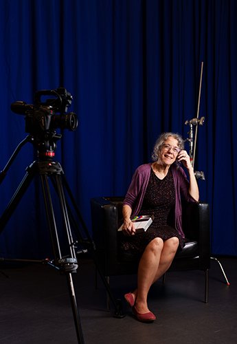 A woman sitting and smiling