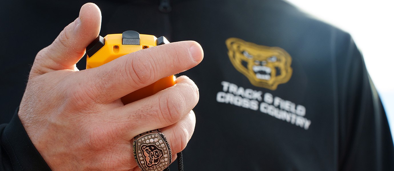 A hand holding a stopwatch