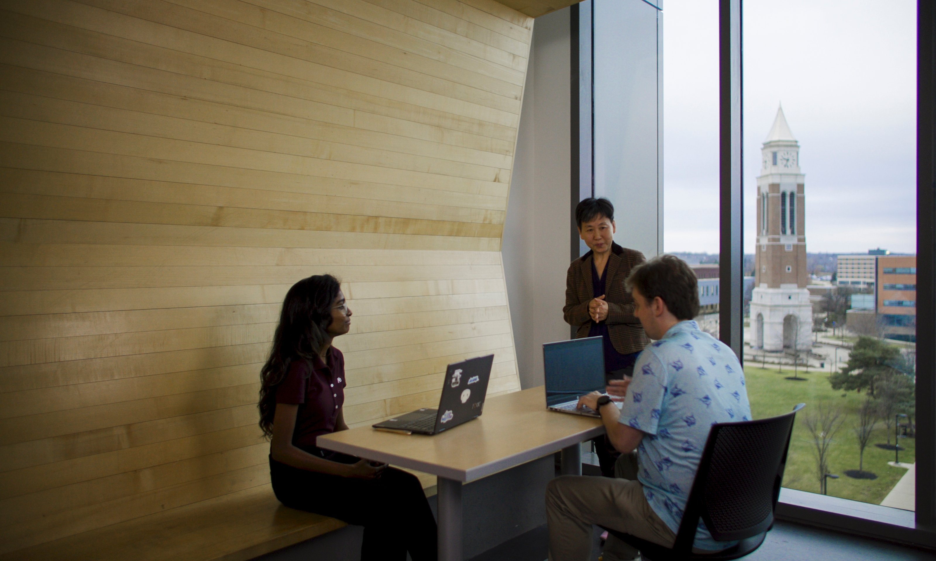 Huirong Fu discussing with others