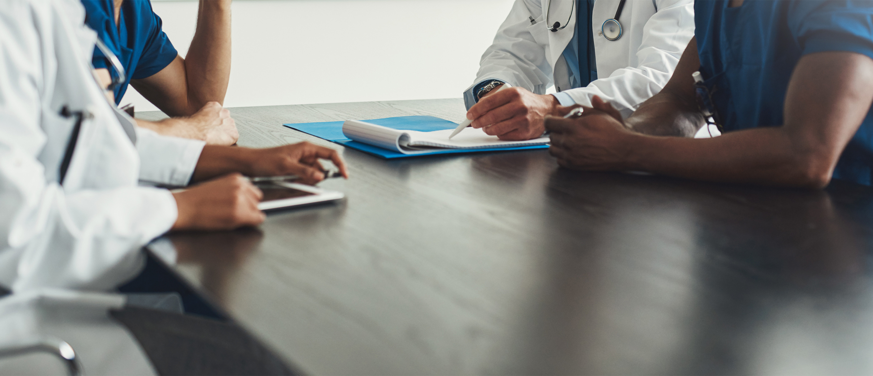 An image of a doctor and patient at a table
