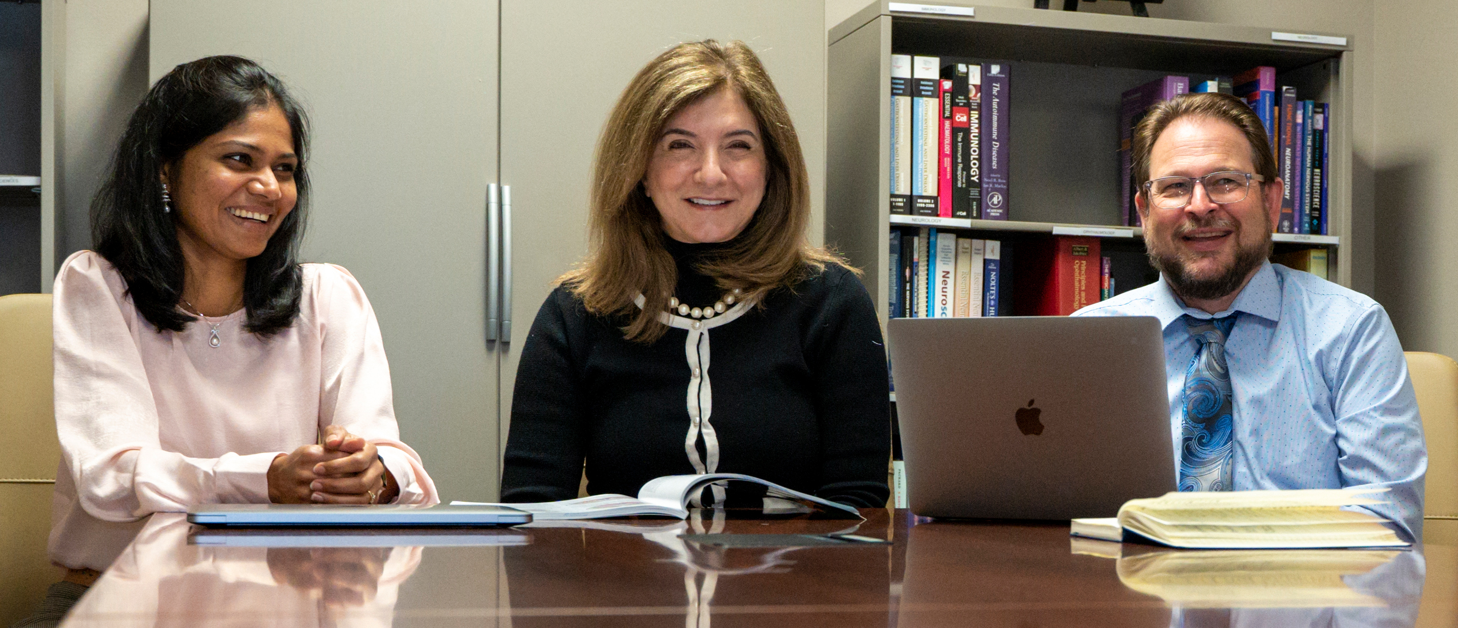 An image of OUWB faculty members sitting at a table