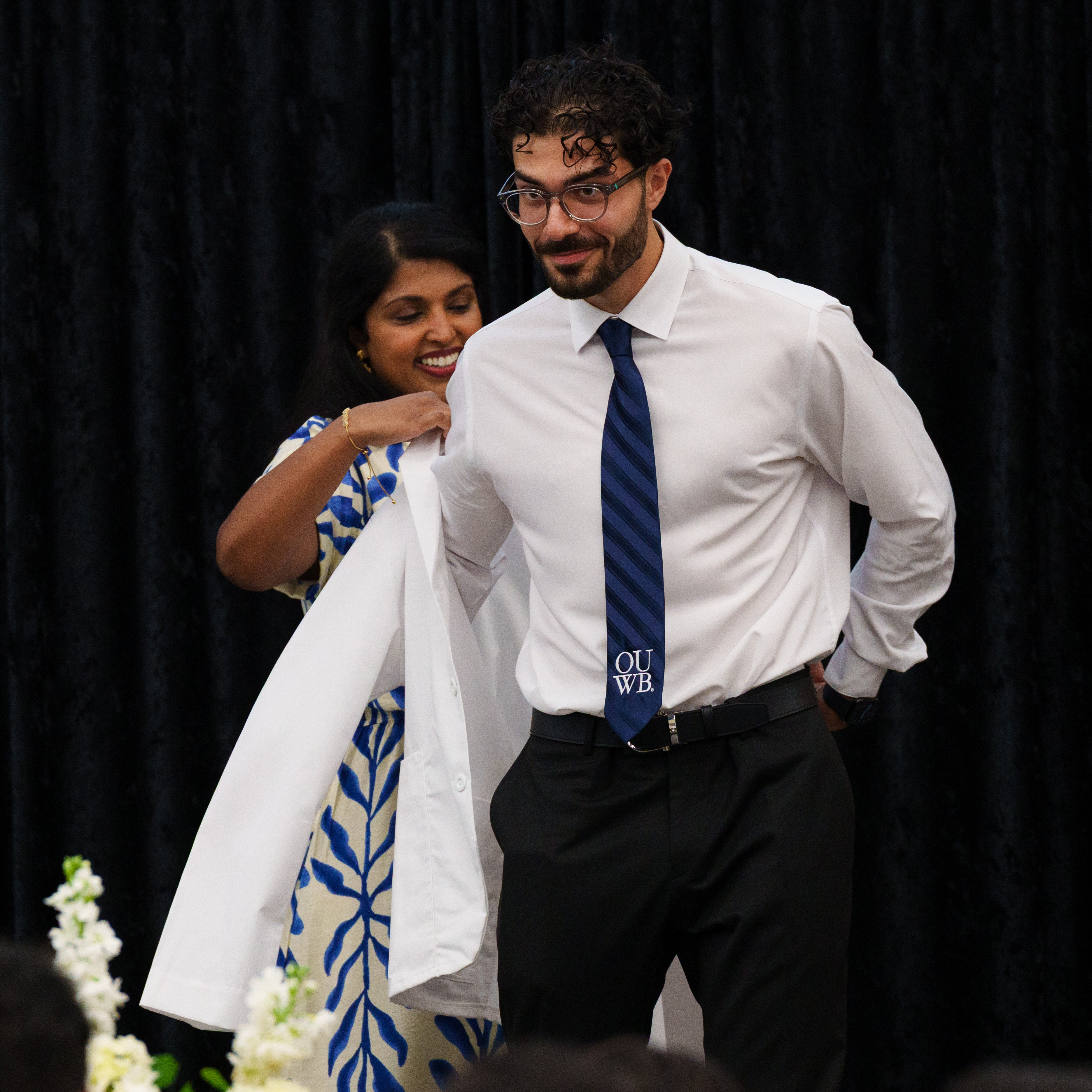 An image of a student receiving a white coat