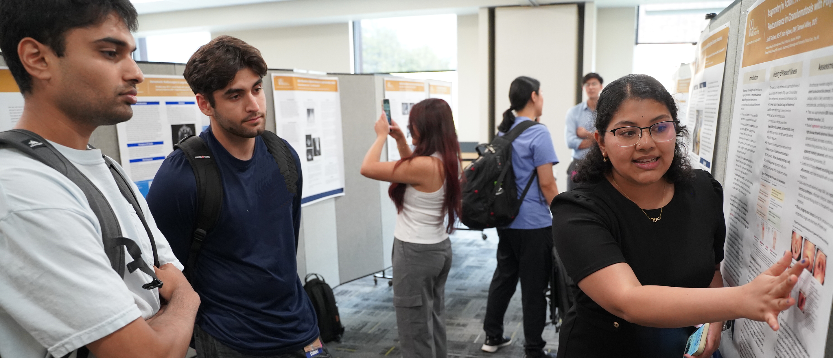An image of a student presenting a poster