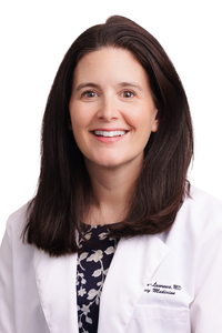 An image of Danielle Turner-Lawrence wearing a white coat