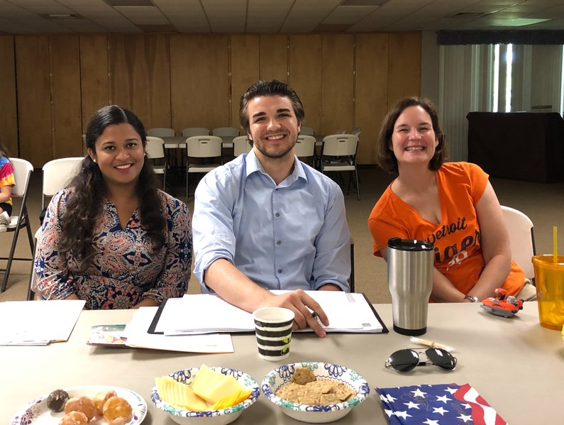 An image of three people sitting at a table