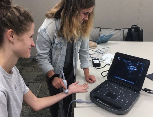 An image of a student using a portable ultrasound