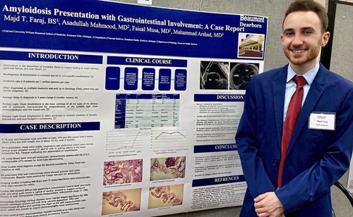 An image of a student in front of a poster