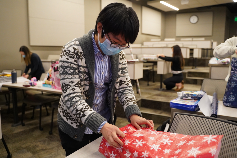 An image of a student wrapping a gift