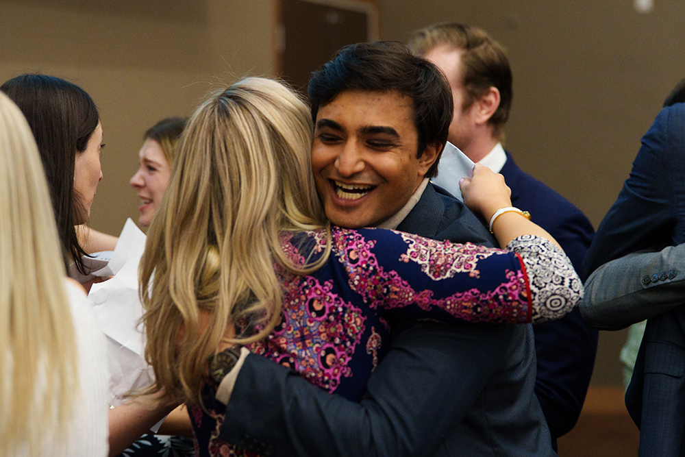 An image of a student hugging another student