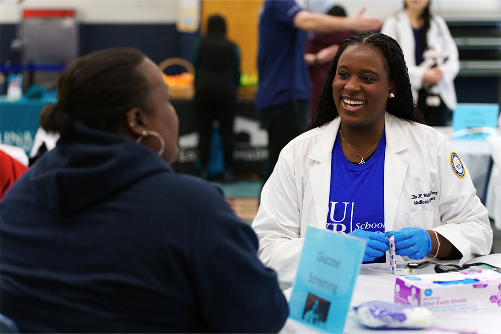 An image of an OUWB student and patient at the fair
