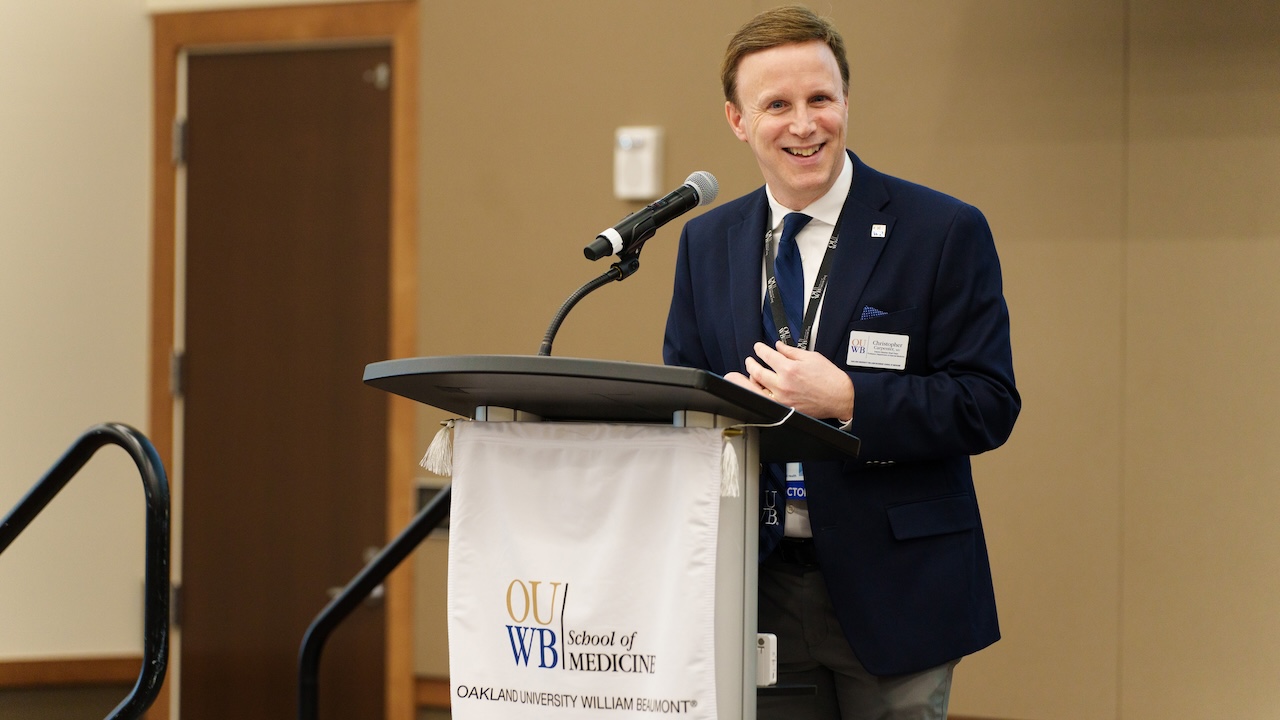 An image of Dr. Carpenter at a podium