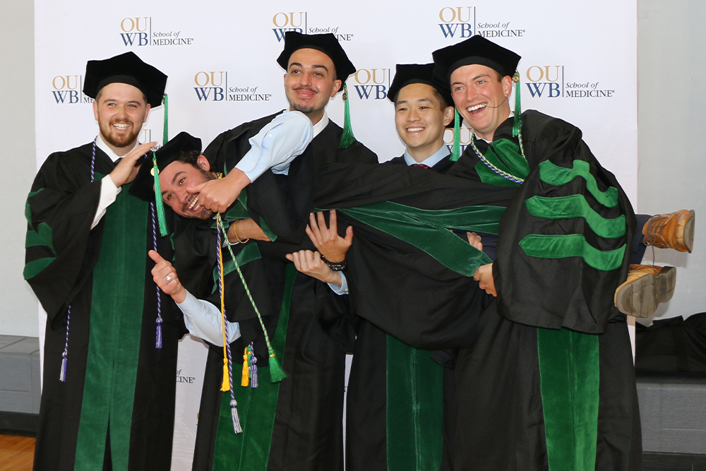 An image of graduates posing for a picture