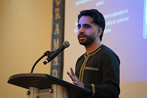 Shayaan Aqil speaks at a podium