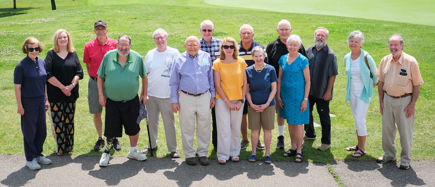 A group of Pioneer Club members posing for a photo outside