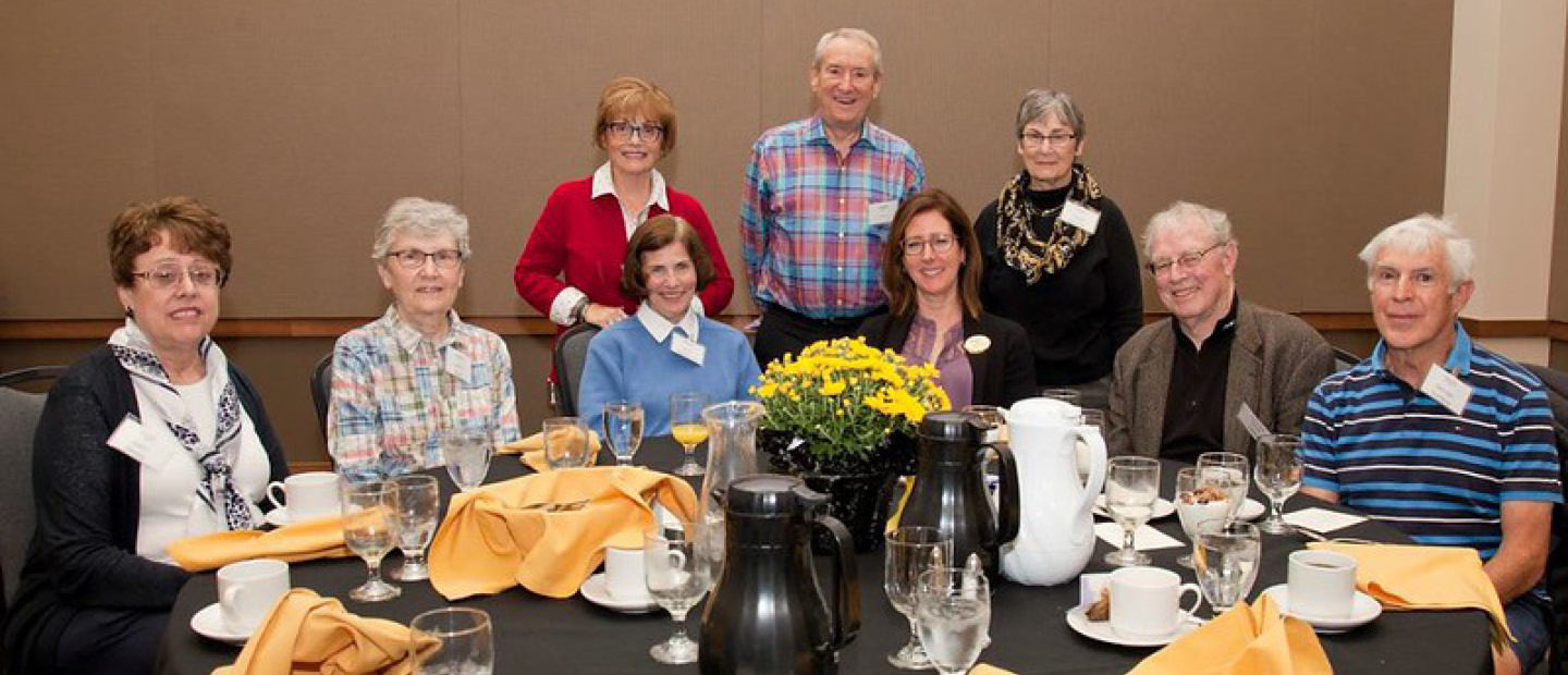 A group of Pioneer Club members posing for a photo at a banquet