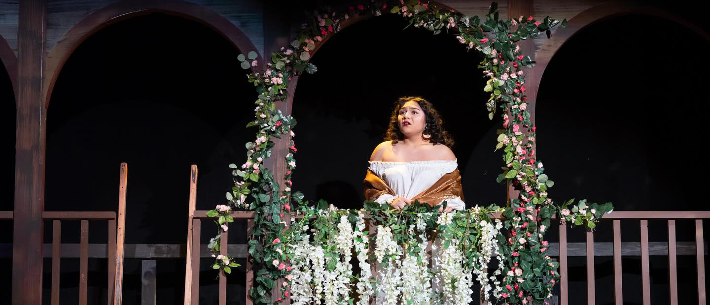 A woman on stage performing in a play